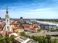 Widok na Bratysławę: wieża katedry, rzeka Dunaj i dachy Starego Miasta.