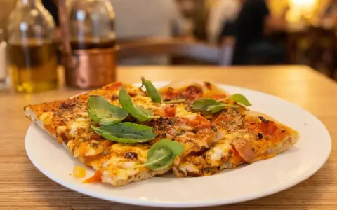 Pyszna pizza na talerzu, idealna odpowiedź na pytanie: gdzie zjeść w Rzymie. W tle butelki z oliwą i widok na restaurację.