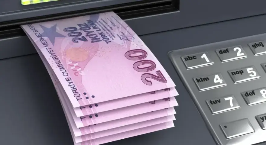 Stos banknotów po 200 lir tureckich wychodzi z bankomatu. Waluta w Turcji, liry, gotowa do odbioru.